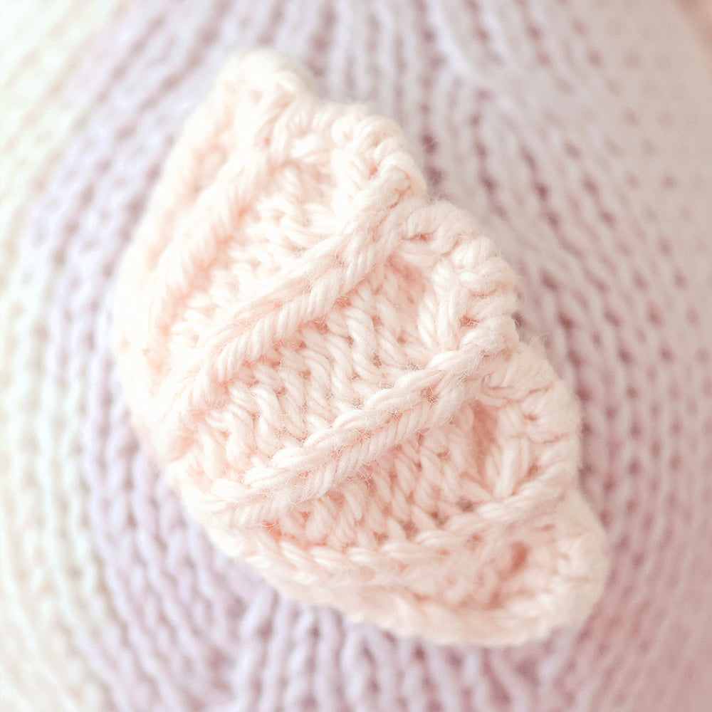 
                  
                    Close-up of Cuddle + Kind Baby Seahorse (Lilac), showing delicate pink hand-knit fin detail with textured stitches.
                  
                