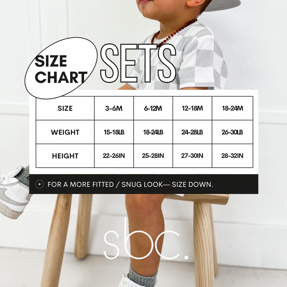 
                  
                    Size chart for a toddler's white shirt and shorties set with tan colored smileys all over it. The chart displays measurements for sizes 3-6 months, 6-12 months, 12-18 months, and 18-24 months. This unisex outfit is made from ribbed bamboo fabric, ensuring a comfortable fit for both baby boys and girls. Perfect for selecting the right size for your little one's stylish and eco-friendly wardrobe.
                  
                