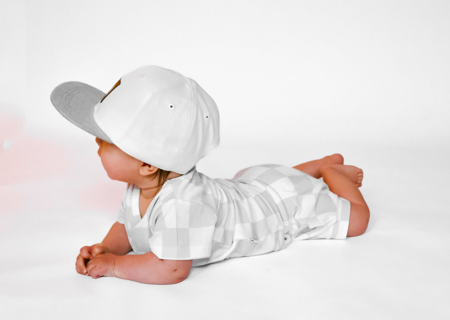 
                  
                    Photo of a baby boy wearing a stylish grey and white checkered shirt and shorties set for toddlers. The design features a ribbed bamboo fabric, offering comfort and breathability. Available in sizes 3-6 months, 6-12 months, 12-18 months, and 18-24 months, this outfit is perfect for both boys and girls, combining trendy patterns with eco-friendly materials.
                  
                