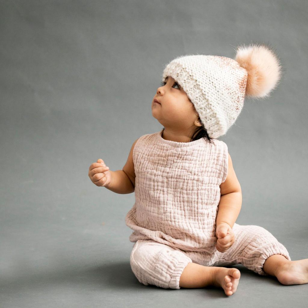 
                  
                    Cream and Rose Gold Pearl Metallic Hat with Fur Pom
                  
                