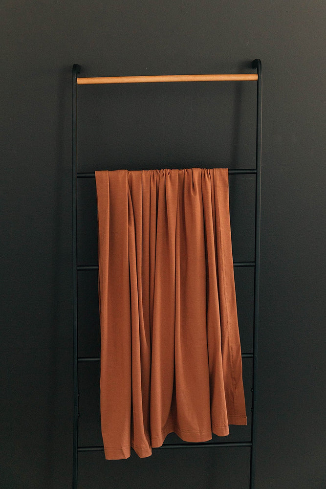 
                  
                    Rust Stretch Swaddle
                  
                